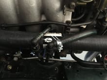 Routed over the Re-Route Upper Radiator Hose