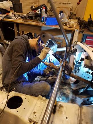 Left foot welding the OEM dash bar's mounting bracket for the steering column. Careful design and fabrication got us within mm of our target here.