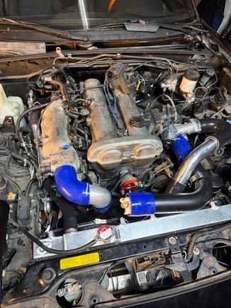 Reconfigured my intercooler piping for the 3rd time. 

Deleted the charcoal canister with the hopes of being able to run my intake to the passenger side of the engine bay. 