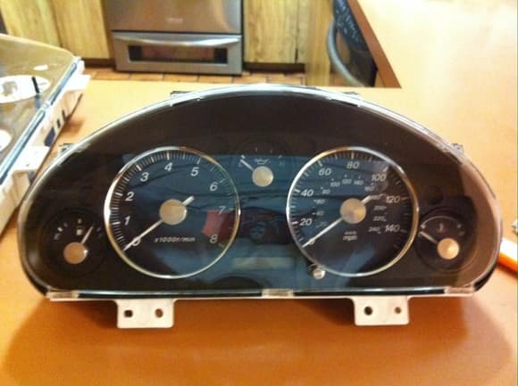 My reworked gauge cluster. Chrome rings are attached to the 10AE bezel I used and the needle caps I bought 3-4 years go.
