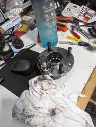 Stock front hub.  Has been repacked before as it came with 3 types of grease.  Red, Crusty, and Yellow.  I was able to pull this bearing apart by hand...so out it goes.