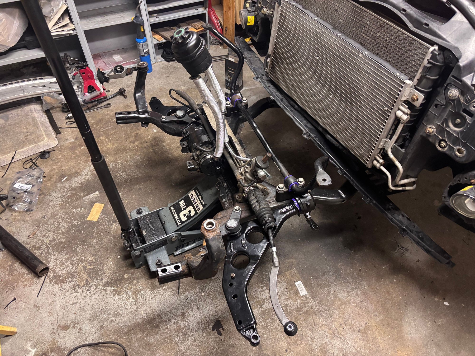 New power steering hoses in this photo. The old ones were so worn, I was able to twist the hoses even with the clamps on. Now with the new ones in, they are able to hold the res up fully!