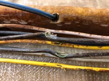 Check this out. When they drilled this hole for a wire to go through this stiffener, they drilled into the wiring harness luckily the wires did not ground out over the boats life and burn the thing up.