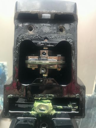 Took the rear cap off and used a large screwdriver to move the shift lever in order to disconnect the cable.

No luck, it is quite stuck.

Is that greeny white grease normal, or could it be water mixing with the oil?

Any further suggestions to get it unstuck?