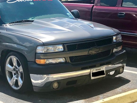 My neighbors truck cowl hood with the HD grille and tahoe z71 valance/fogs