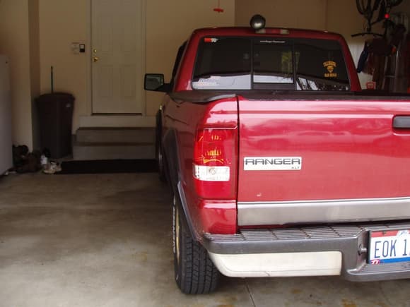 Here is a rear pic.06 emblems. 06 tails. DSG two-tone bumper. Painted bumper pad. Crappy drop in liner hiding the rust holes in the bed. Rear work light. R/F sticker. Gotta rep!! Horsepower adding stickers :)))