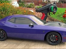 😁👍What the hell...my kyosho hellcat's radio needed a cool grip so I decided to put one of my custom grips on it! Purple car with a dayglow green What yall think?