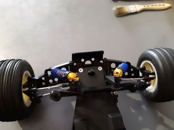 Rusty on the bench-drilled out front A-arms and bumper
