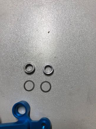 I believe I solved the issue.  You need to shim the bearing, not the arm!