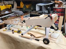 Up on wheels, the square tube is to check the level on the wing.  The top has the cabane mounting plate setting in place to get some interior bracing. the gussets can be seen in the open structure.