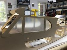 First up, shaping the window cut-outs for the pre-formed windows. Here, I have fitted the front and center panes, but the rear one is giving me ulcers.