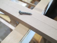 Remember the holes that I drilled earlier in the four basswood blocks that were glued to the fuse main stringers?  In the above photo you see a 4-40 cap head screw that has its end sharpened to a point, much like the tip of a sharp pencil. 