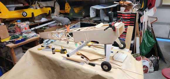 Up on wheels, the square tube is to check the level on the wing.  The top has the cabane mounting plate setting in place to get some interior bracing. the gussets can be seen in the open structure.