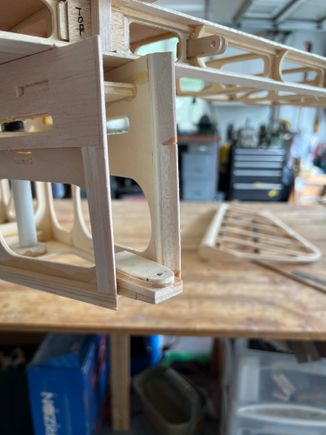 I started by adding balsa pieces to the rear outsides of the fuselage. then you'll see I installed the bottom hinge bracket on a balsa wedge.