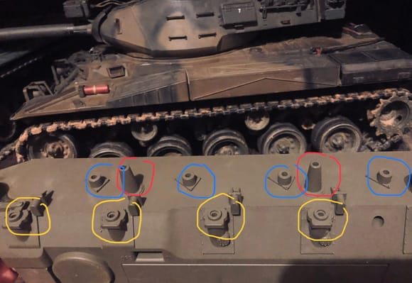 Blue indicates top mounting point for shock, red indicates mounting point for return rollers and yellow indicates mounting point for control arm. 

Front of tank is to left. 