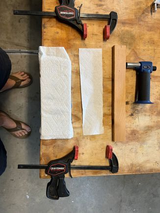 Big paper towel has a 1/2" board under it. Plastic is sandwiched between paper towel. You see the little butane torch it took to provide enough heat: my hot air gun couldn't get it hot enough.