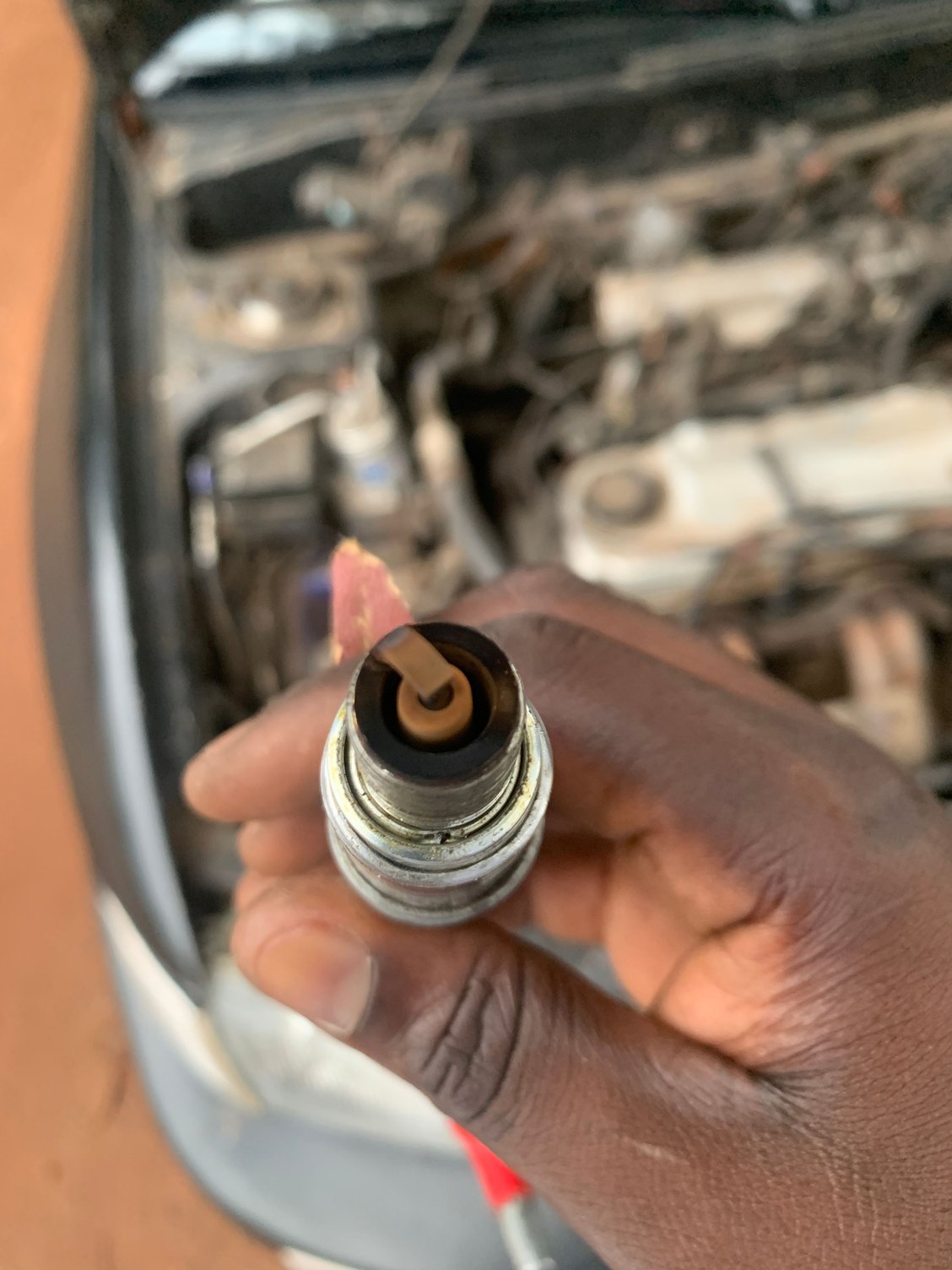 Half white, half black spark plugs. What does this tell you?