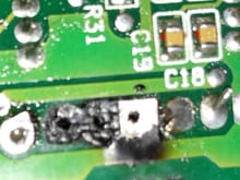 Close-up of the missing eyelets.  Two of them were removed during desoldering.
