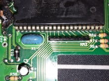 Conformal coating masks the part number on this 42-pin IC