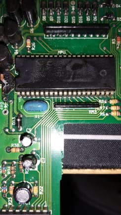 Conformal coating masks the part number on this 42-pin IC