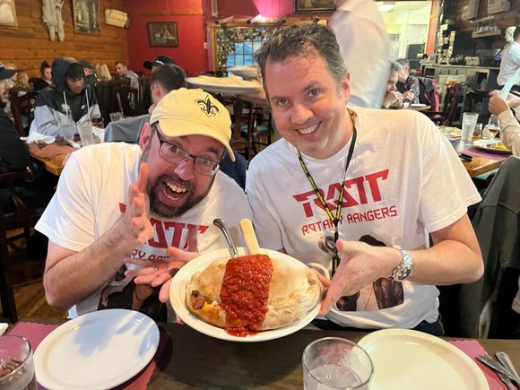 Matt and I eating the giant Calzone.  We made custom shirts with "RATT Rotary Rangers" for the trip.