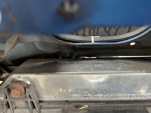 From the engine bay, looking down at the top of the radiator.