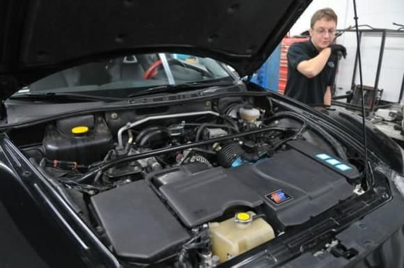 Engine Bay Before. The guy in the picture is Adam from FD3S Engineering.