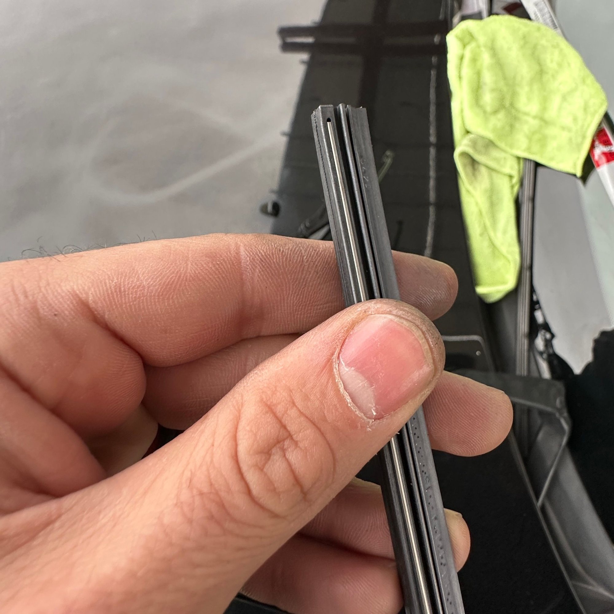 When you get to the end, stretch the wiper insert so that the metal tab fully seats into the slot. At this point, it should be locked in and will not fall out.
