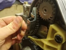 The oil pump chain tensioner comes with a nifty little clip that keeps the the tensioner compressed until your ready and it’s all assembled , pull the clip off , bingo chain tensioner.