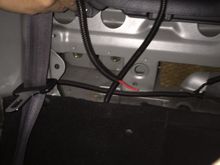 The cable will go into the trunk through behind the passenger seat as shown.