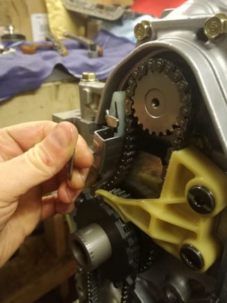 The oil pump chain tensioner comes with a nifty little clip that keeps the the tensioner compressed until your ready and it’s all assembled , pull the clip off , bingo chain tensioner.