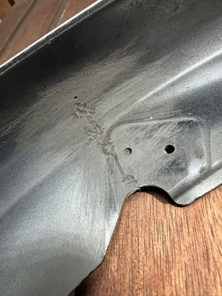 Looks like someone else tried to repair the area with a welder. Sanded with 120 grit. 