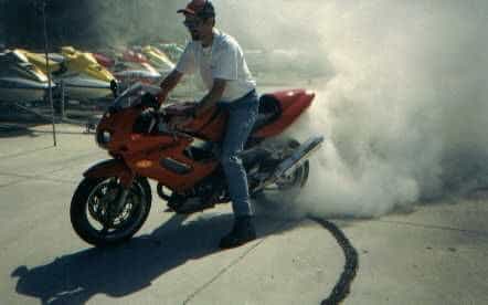 Another old picture of me toasting up the the rear tire before I installed a new Michelin Pilot.  This pic is so old its before I had my lower installed and still had my old Two Brothers exhaust.