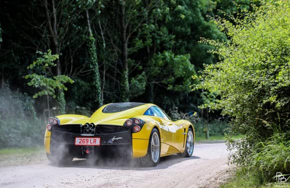 Yellow Huayra kicking up dust. By Pure Power Photography