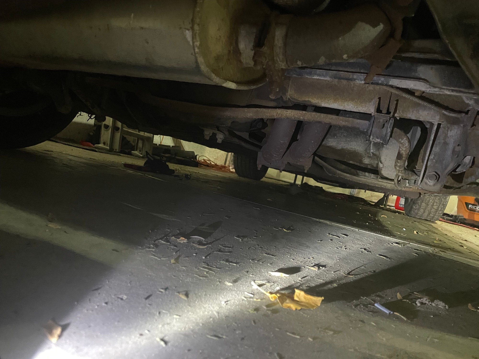 Coming down from behind the rear axle 