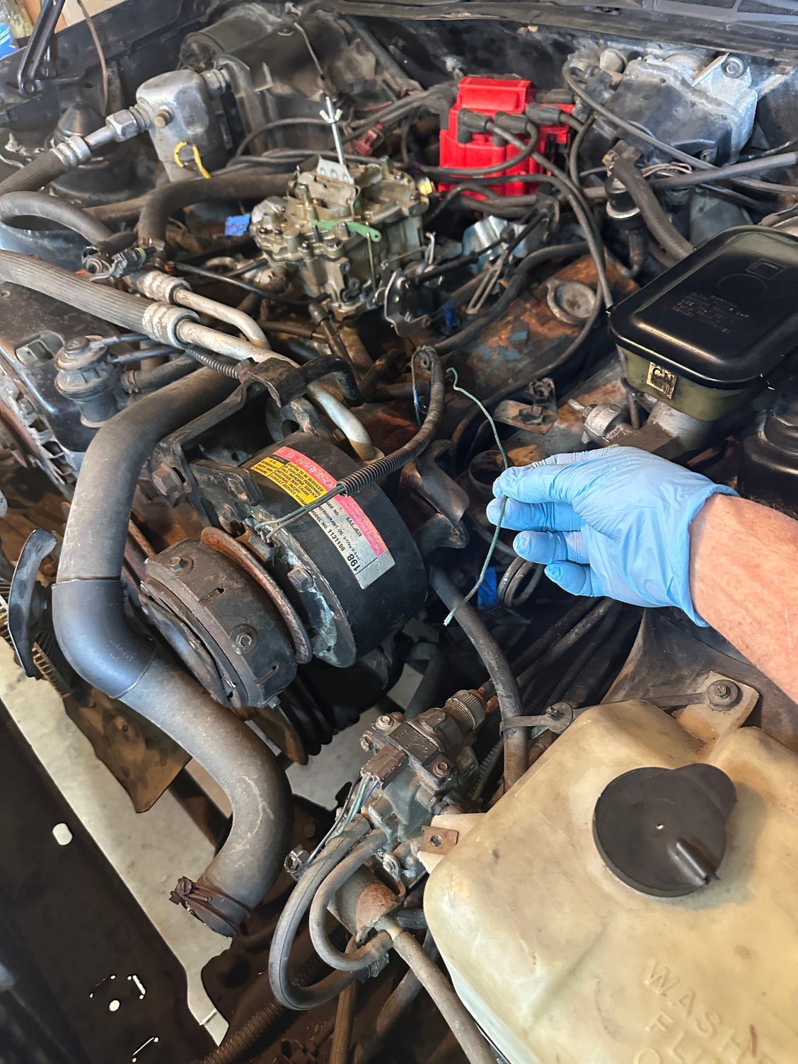 I was pulling off smog stuff and accidentally tore this loose. It came from somewhere underneath the number 2 spark plug (front driver side)