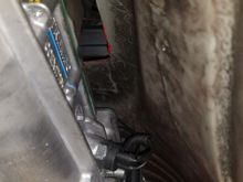 Here, you can kinda see where the front two shifter bolts tuck under the front of the trans tunnel.... looking at it, there MAY be clearance to remove the 10mm bolts with the trans in, but they are pretty dang long... I'm certainly going to try to do so before I lower it for my new shifter.  Dang it!