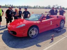 Let's all watch how fast the NASCAR guy can change the Ferrari tires...lazy asses. (Casy Quinn of Unbalanced Engineering is standing on the far left)