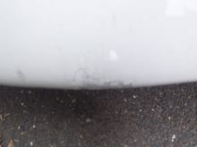 chip on very bottom of front bumper