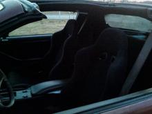 New black interior.  Black racing front seats. Black back seats, panels, carpet. Still need black seat belts.