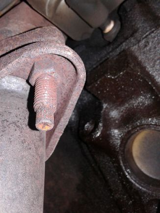 It appears to be a threaded hole with no bolt in it that's causing a slow oil leak.