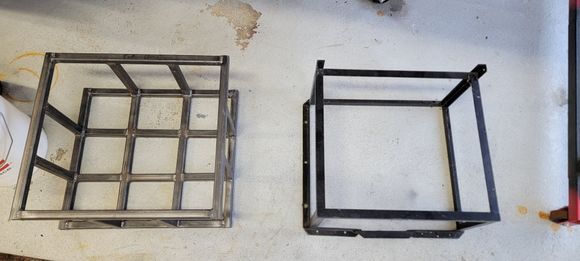 Throw back to the past. On the right is my old fuel cell cage made from angle iron. It worked, but I never liked how flimsy it was, and how the metal frame contacted the aluminum cell. 