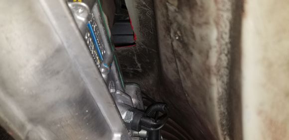 Here, you can kinda see where the front two shifter bolts tuck under the front of the trans tunnel.... looking at it, there MAY be clearance to remove the 10mm bolts with the trans in, but they are pretty dang long... I'm certainly going to try to do so before I lower it for my new shifter.  Dang it!