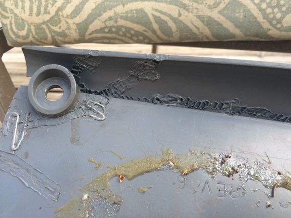 Back side of rear trim piece that had cracked and pieces broken off.  Used a wood burner to "weld" plastic back together.  Metal pieces were heated and embedded in the plastic to add rigidity.