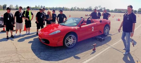 Let's all watch how fast the NASCAR guy can change the Ferrari tires...lazy asses. (Casy Quinn of Unbalanced Engineering is standing on the far left)