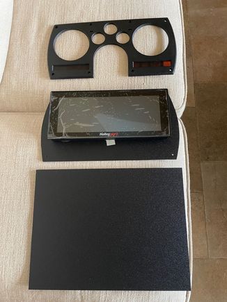 Bought some textured, 1/8" thick ABS plastic from Amazon.  Inexpensive, looks good, and easy to work with.  You can see that one of the pieces is already cut out to the proper shape and is under the ProDash.  This piece of ABS mounts the ProDash to the dashboard.  I call it the inner piece.
