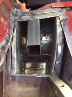 Horizontal bar stock with vertical plate welded into Driver side rear sub frame