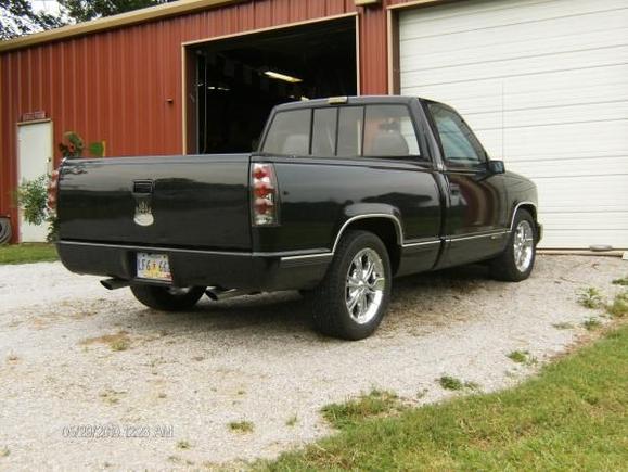 Rear view: roll pan, single in/dual out muffler w/ chrome tips, tail lights, diamond plate bed caps.  Been lowered 2" in front and 4" in rear.