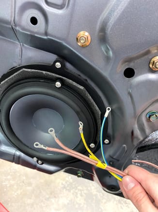 Here are the 6.5" woofers mounted in BoomMat foam cups and its adapter to fit it in the factory Bose bolt pattern. Note: I did have to trim the plastic surrounding the grill on the inside of the door card since that spacer sticks everything out a little bit further. 