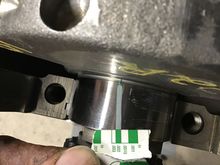 Checking the plastigauge width to verify bearing clearances.